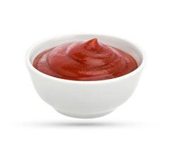 Bowl of tomato ketchup isolated on white photo