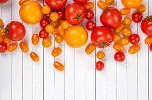 Tomato harvest on wooden background photo