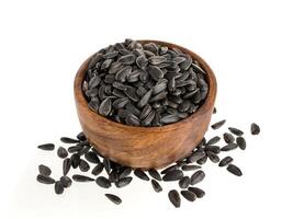 Pile of black sunflower seeds isolated on white photo