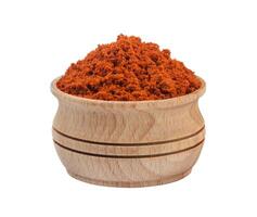 Red paprika powder in wooden bowl isolated on white background photo