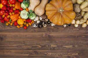 Harvest on wooden table background photo