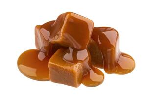 Caramel candies and caramel sauce isolated on white background photo