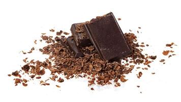 Broken chocolate. Heap of ground and grated chocolate isolated on white background photo
