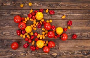 Colorful tomato on wooden table, top view photo