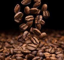 Falling coffee beans on dark background photo