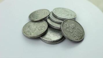 Rupiah coins stacked on a rotating display stand, the beginning of investing in wealth, saving coins of small value video