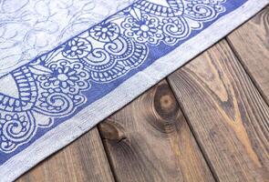 Blue cloth on wooden table, top view photo