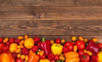 Colorful vegetables harvest on wooden background photo