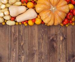 Autumn vegetables harvest on wooden background photo