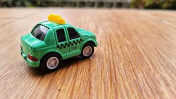 Toy cars in the shape of a green TAXI. Suitable for boys photo