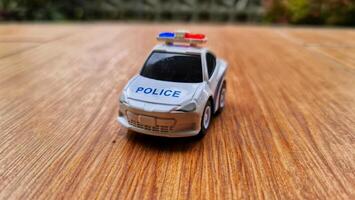 Close up bokeh photo of a boy's toy police car.