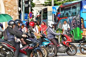 Kuala Lumpur, Malaysia on May 21, 2023. Several cars stop at a red light near the Dataran Merdeka square and Sultan Abdul Samad Building. photo