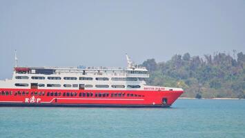 Merak, Indonesia on June 8 2023. A red ferry boat is heading towards the port of Merak. photo