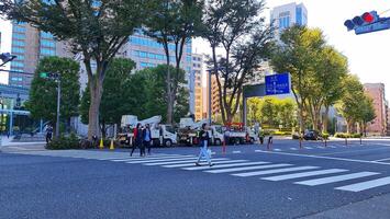 Tokyo, Japan on October 1, 2023. Several people are walking on a zebra cross. photo