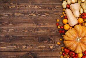 Harvest on wooden table background, top view photo