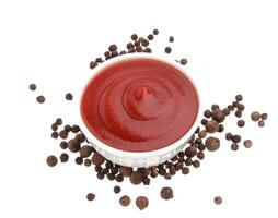 Ketchup and black pepper isolated on white photo