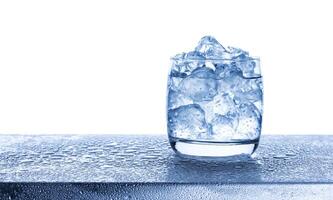 Water with crushed ice cubes in glass on white background photo