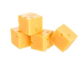 Cubes of cheese isolated on white photo