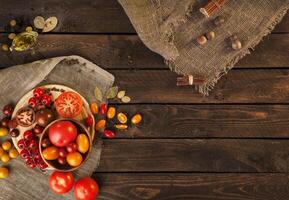 Tomatoes on wooden table, top view photo