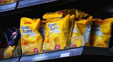 Manila, Philippines on September 29 2023. Calbee Honey Butter Potato Chips snack in the window of a shop at the airport photo