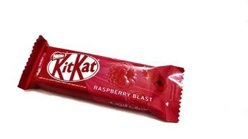 Medina, Saudi Arabia on February 29 2024. 2 finger KitKat chocolate with raspberry blast flavor, with Arabic writing. A signature crispy wafer center, balanced with smooth milk chocolate, raspberry. photo