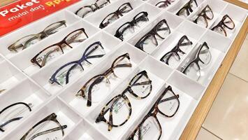 Bekasi, Indonesia on December 12 2023. Several glasses are neatly arranged in an glasses shop window. photo