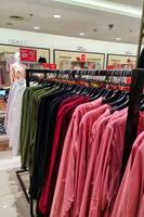 Bekasi, Indonesia on December 20, 2023. Rows of hangers with the words several women's clothes hanging on them photo