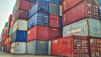 Jakarta, Indonesia on December 6, 2023. Stacks of colorful containers at a logistics warehouse in Cakung. photo