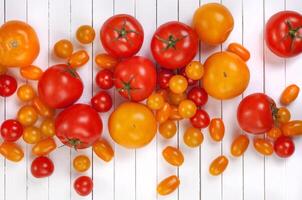 Tomato harvest on wooden table background photo