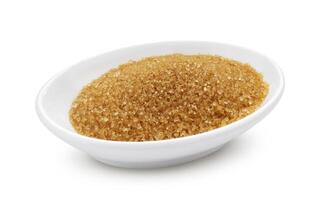 Brown sugar in bowl isolated on white background photo