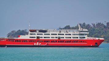 Merak, Indonesia on June 8 2023. A red ferry boat is heading towards the port of Merak. photo