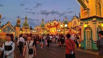 Chiba, Japan on September 30, 2023. Visitors to the Toy Story Mania ride at night. photo