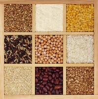 Groats in square wooden box, collection of cereals, beans and seeds, top view photo