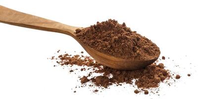 Pile of cocoa powder isolated on white background, cinnamon powder in wooden spoon photo