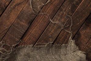 Old jute texture on wooden table background photo
