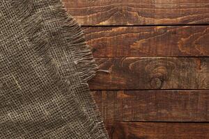 Wood table with old burlap cloth photo