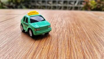 Toy cars in the shape of a green TAXI. Suitable for boys photo