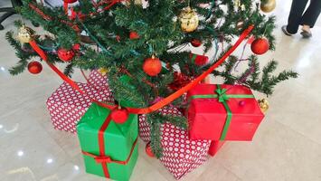 Pile gifts under the Christmas tree. Merry Christmas. Colorful gifts. photo