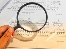 A magnifying glass is often used to view and magnify detailed shop drawings photo