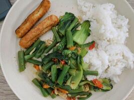 Sauted chickpeas and pokcoy with fried nuggets and rice. photo