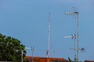 Television antennas that are mounted on the roof of the house photo