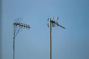 Television antennas that are mounted on the roof of the house photo