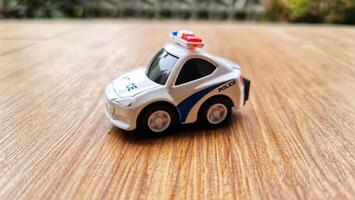 Close up bokeh photo of a boy's toy police car.