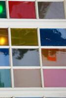 Close up photo of colorful glass of a window. Very attractive and suitable for cheerful home interiors or even retro themes.