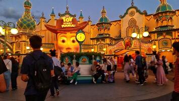 Chiba, Japan on September 30, 2023. Visitors to the Toy Story Mania ride at night. photo