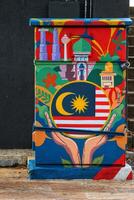 Kuala Lumpur, Malaysia on May 22, 2023. An electrical panel decorated with paintings of the Malaysian flag and landmarks. photo