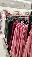 Bekasi, Indonesia on December 20, 2023. Rows of hangers with the words several women's clothes hanging on them photo