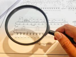 A magnifying glass is often used to view and magnify detailed shop drawings photo