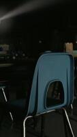 un fila de azul sillas en un oscuro habitación video
