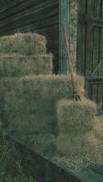 A rustic barn with hay bales in the foreground video